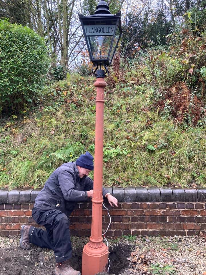 Volunteer fixing a lamp