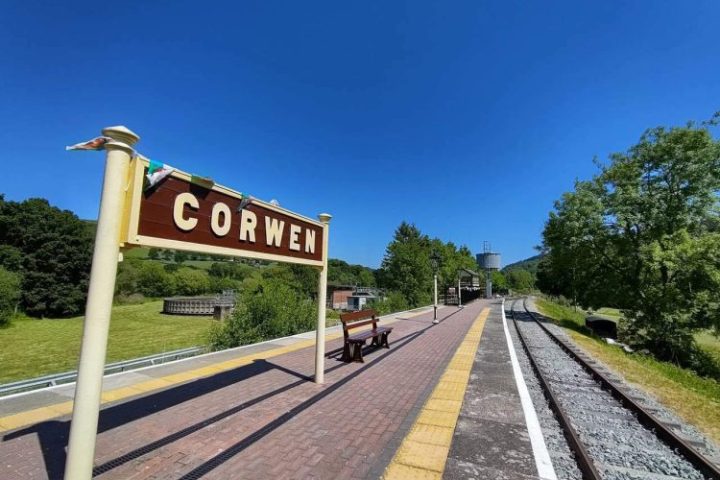 Corwen Station platform showing the platform sign under a blue sky