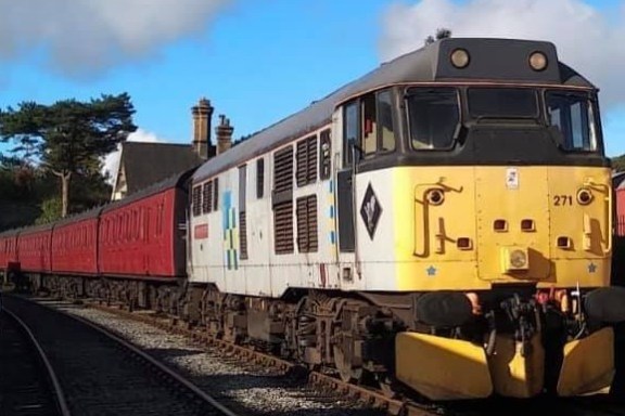 a train engine carrying carts down a track