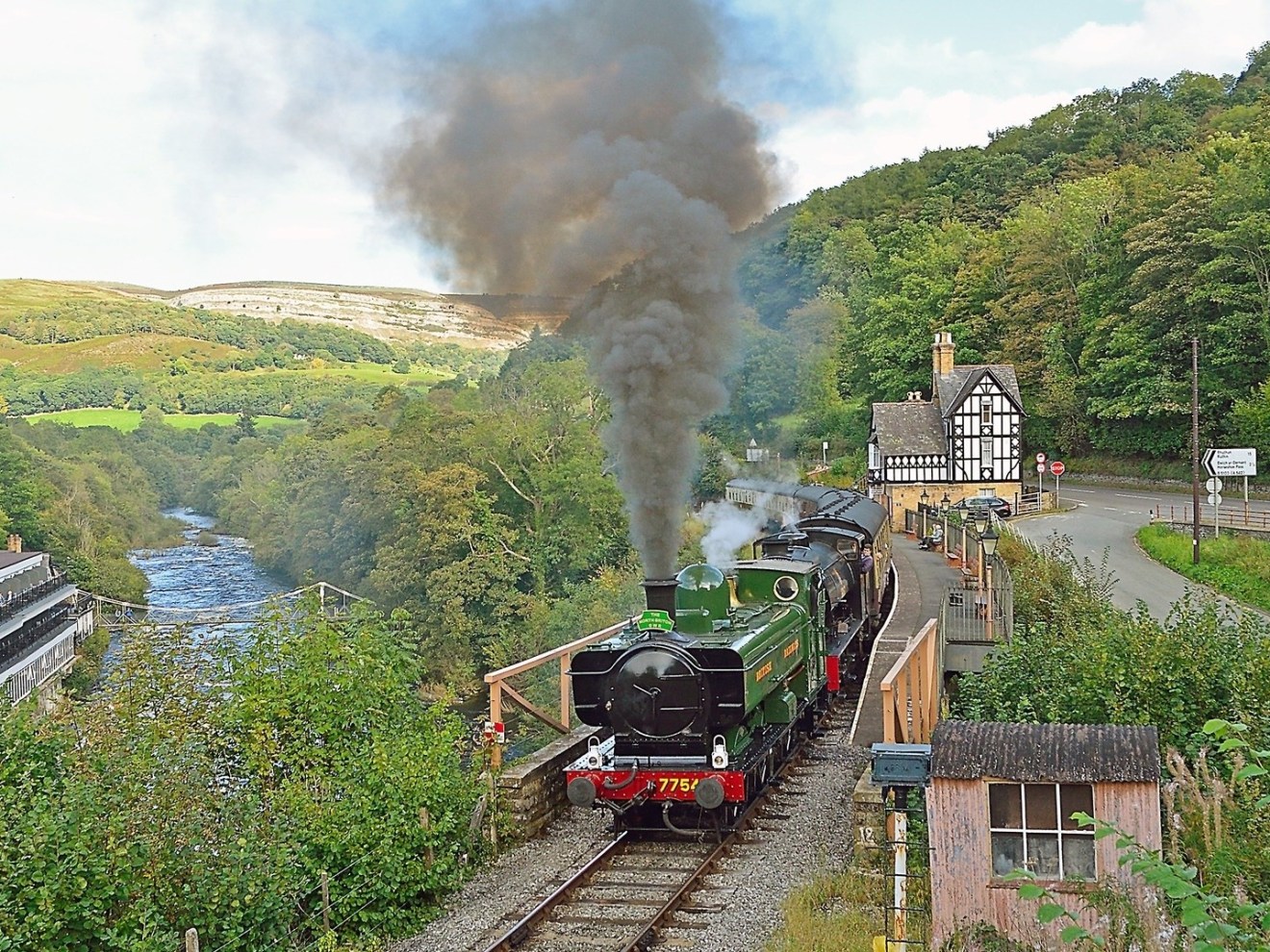 a train on a track with smoke coming out of it