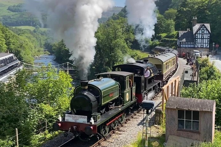 a train on a track with smoke coming out of it