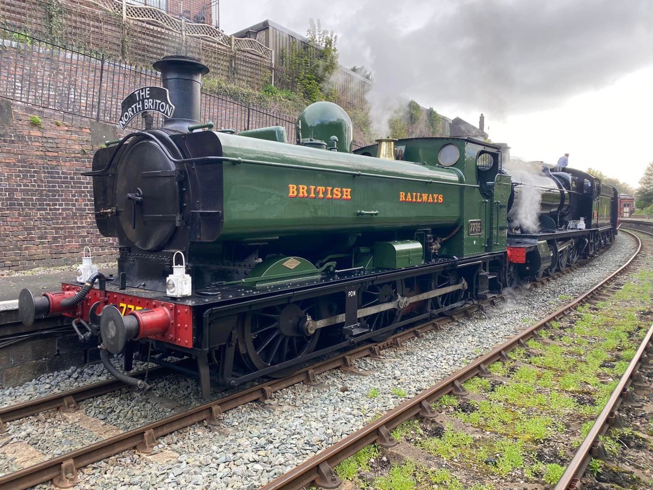 a steam engine sitting on a train track