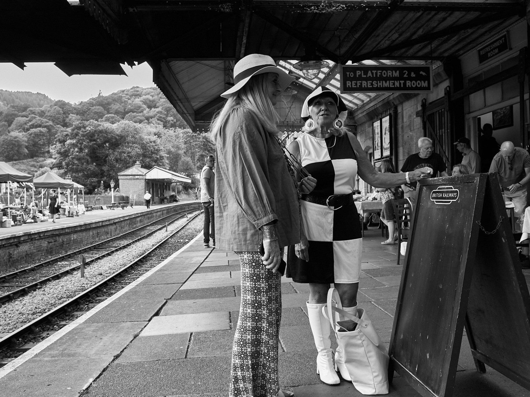 people standing on a platform at a train station